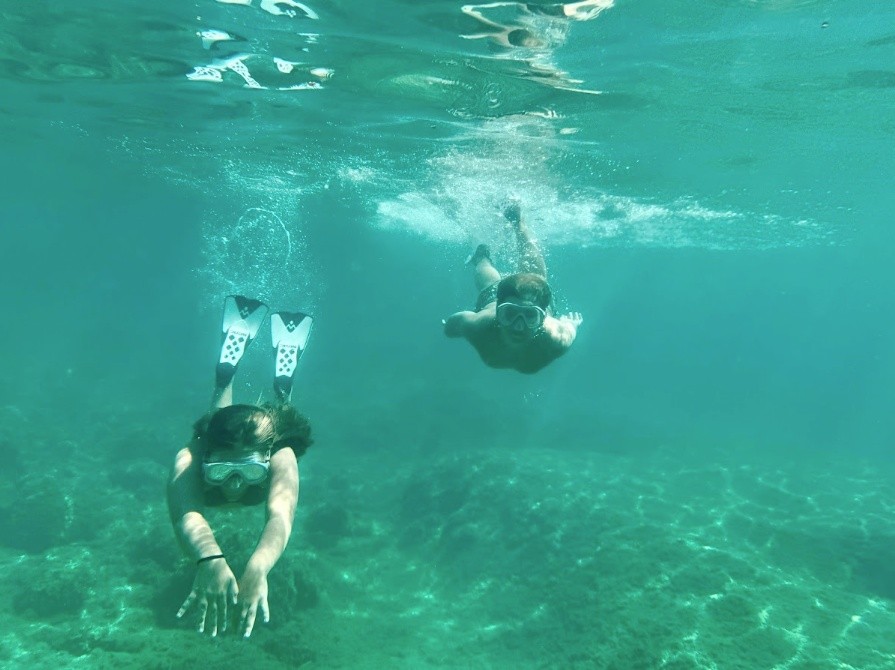 Guests snorkeling in clear Caribbean water.