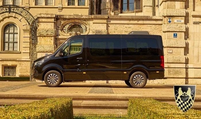 Black van parked in front of a historic building with intricate architecture.