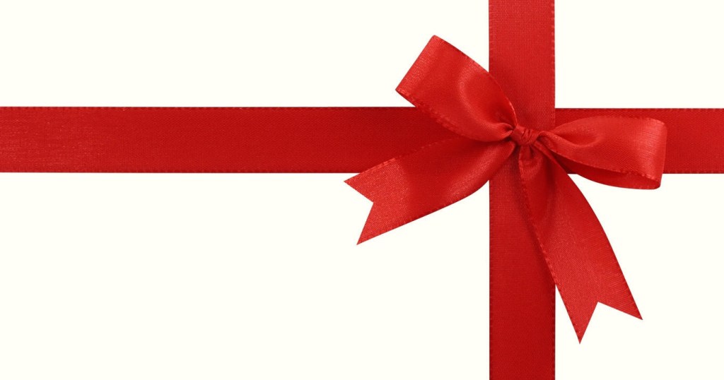 Red ribbon tied in a bow on a white background, resembling gift wrapping.