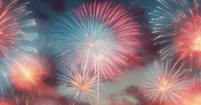 Colorful fireworks explode in a night sky, featuring mainly blue and pink bursts.
