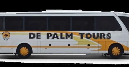 White tour bus with 'De Palm Tours' logo on the side.