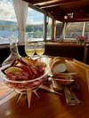 Bread and cheese with wine on a table overlooking a lake view.
