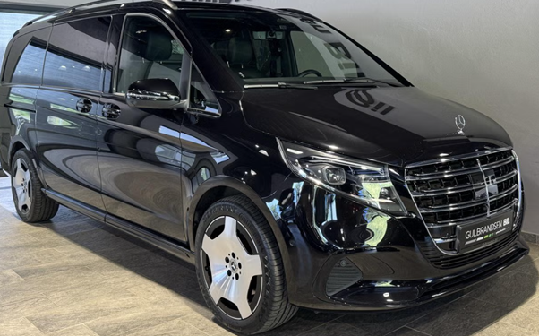 Black luxury van with a shiny exterior parked indoors.