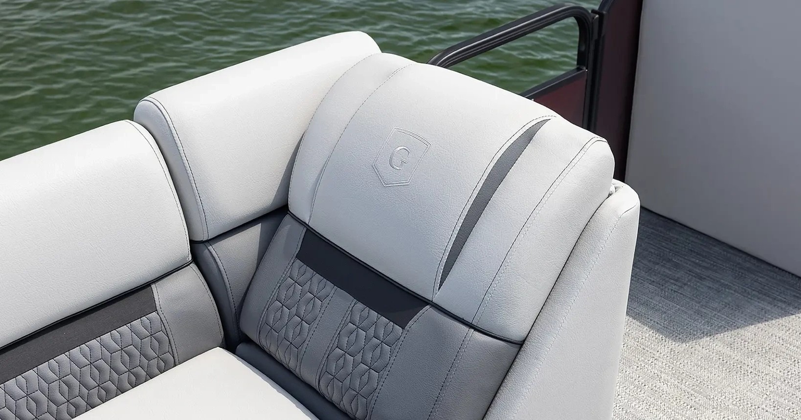 Grey boat seats with a geometric pattern on a pontoon.