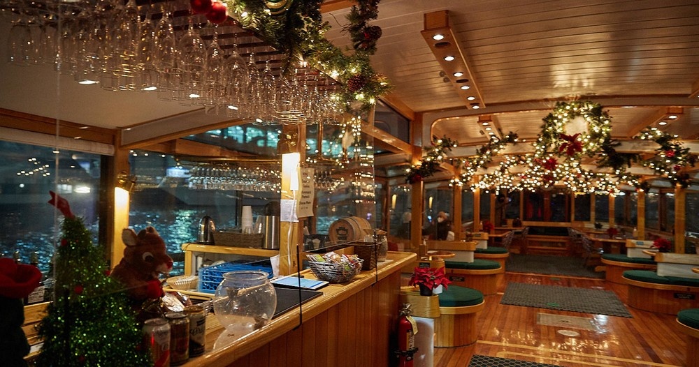 Festively decorated boat interior with garlands and lights.