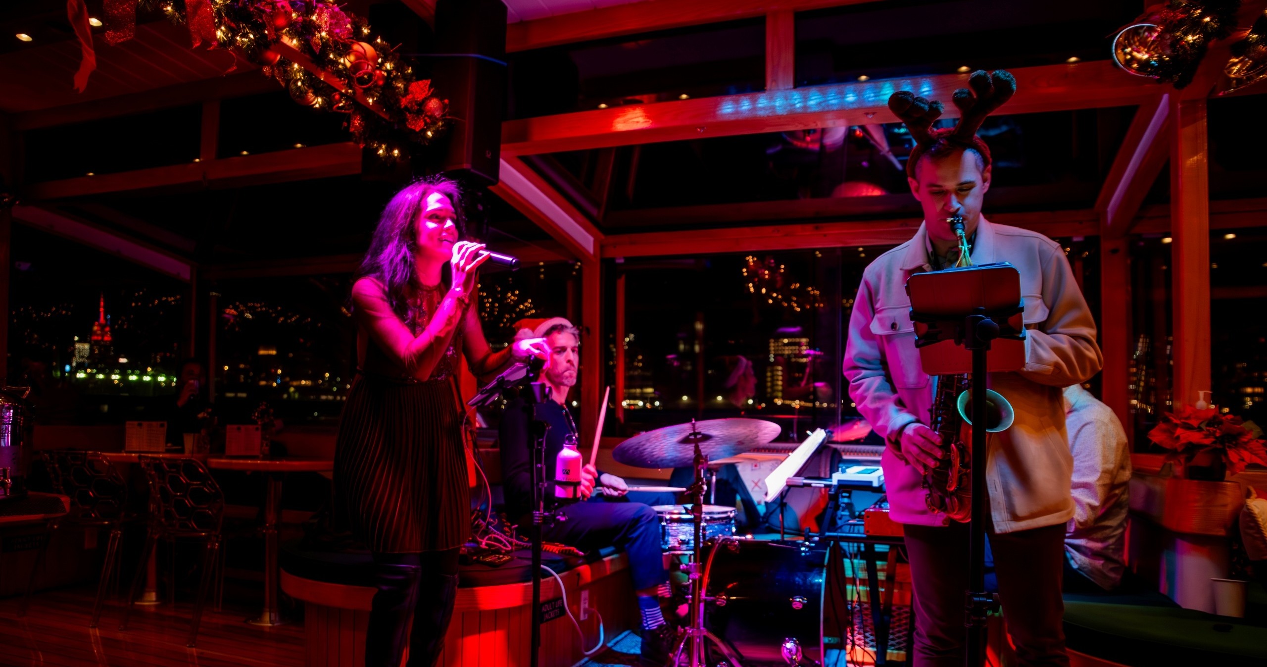 Jazz band performing in a dimly lit venue with festive decorations.