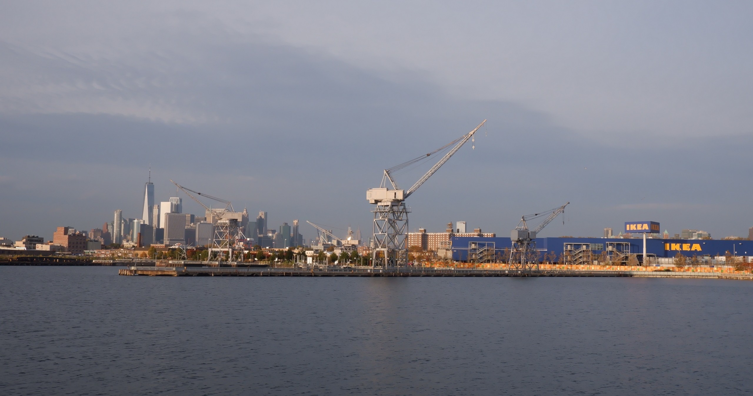 Seaside industrial area with cranes and IKEA buildings.