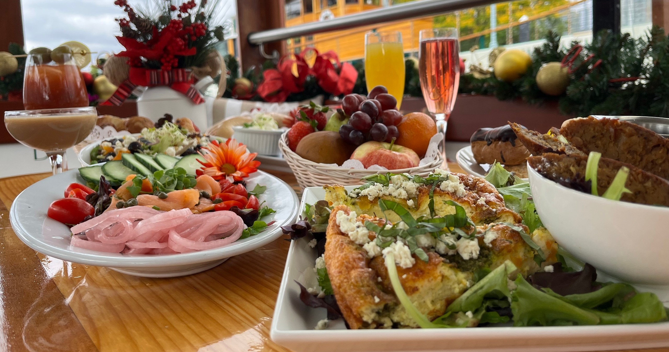 Festive table with various dishes, salads, breads, fruits, and drinks.