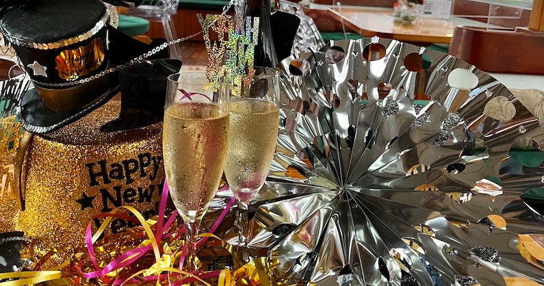 New Year's Eve decorations with champagne glasses and hats.