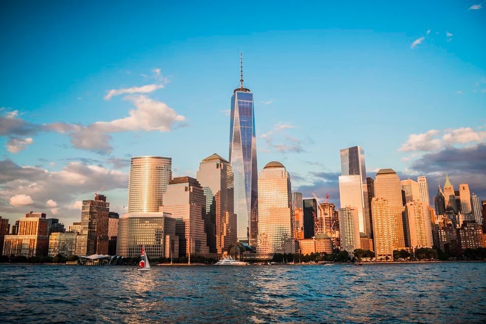 Skyline of Lower Manhattan with One World Trade Center during sunset.