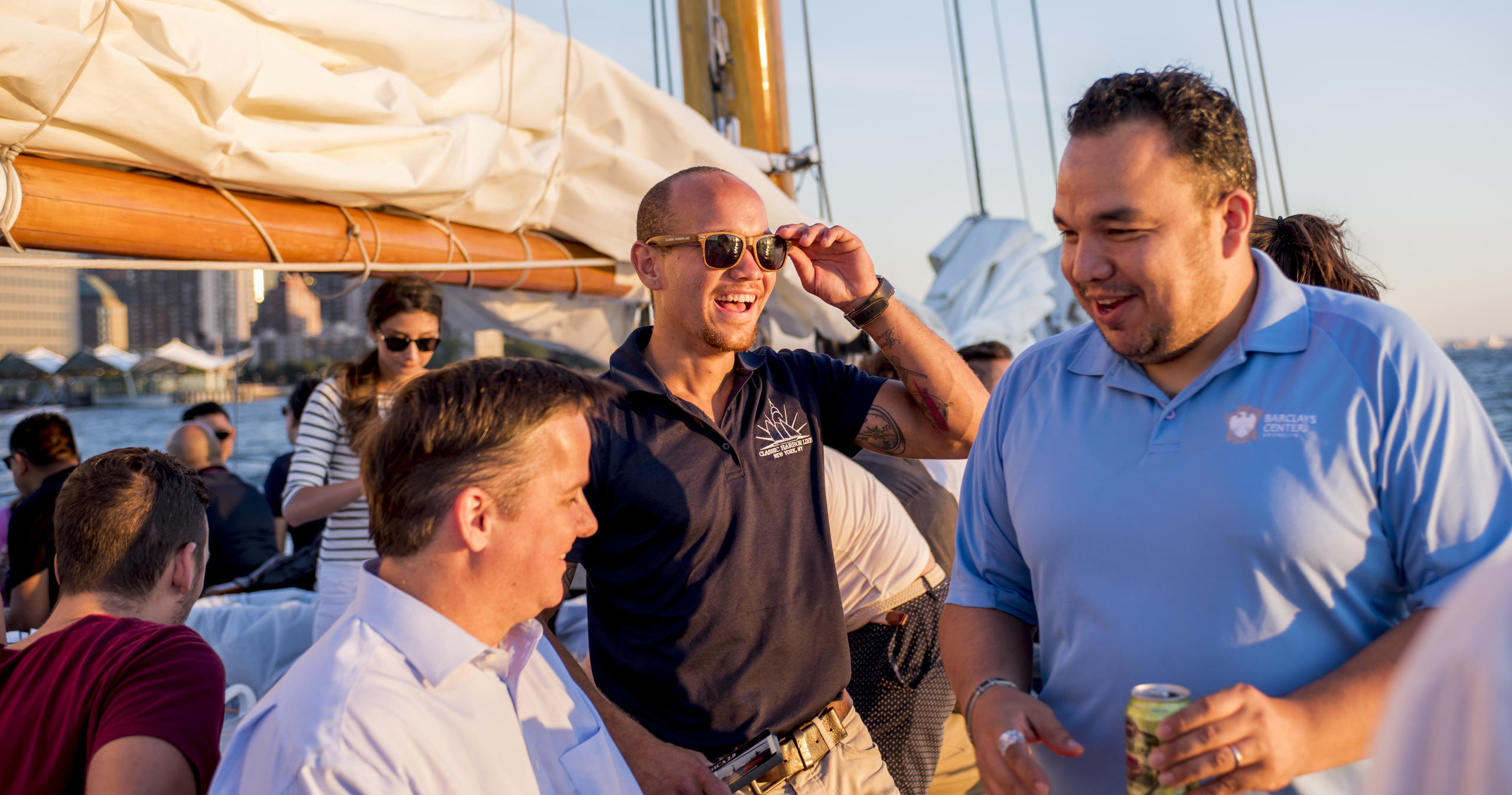 Group of people socializing on a sailboat.