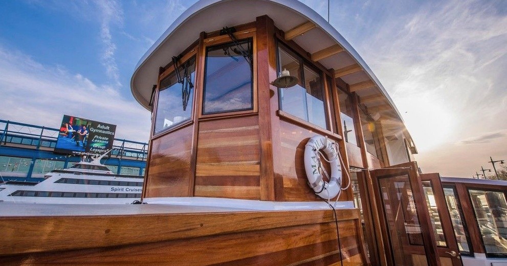 Wooden cabin of a boat under a blue sky with clouds.
